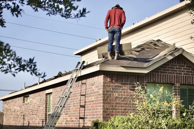 Professional roofer working on a residential roof in The Retreat at Twin Lakes